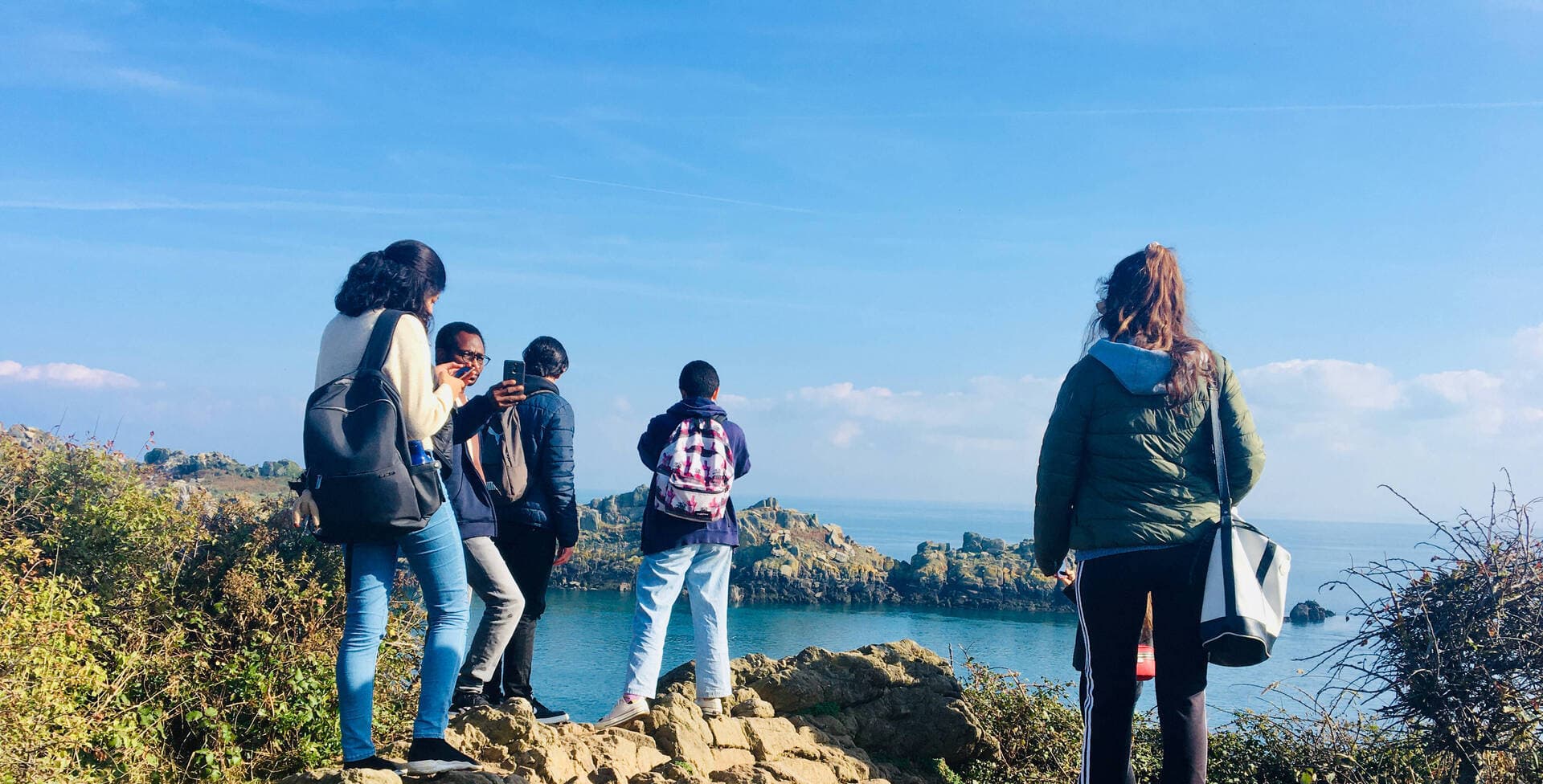 Friends overlooking the horizon of the sea